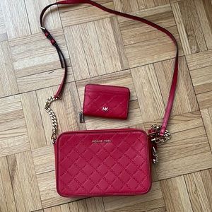 Like new Michael Kors red embossed crossbody bag and wallet set.